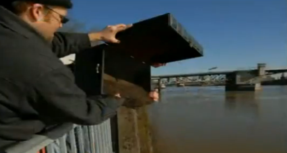 Founder of the Oregon Tea Party, Geoff Ludt, pouring TEA into Portland's Willamette River. 